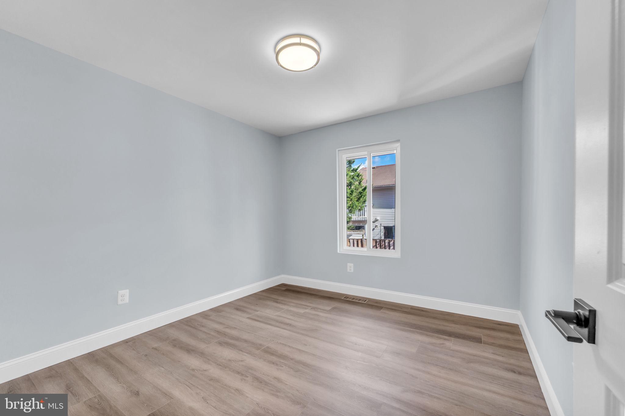 13314 Apgar Place Herndon, VA 20170 - Photo 23 of 39 an empty room with wooden floor and windows