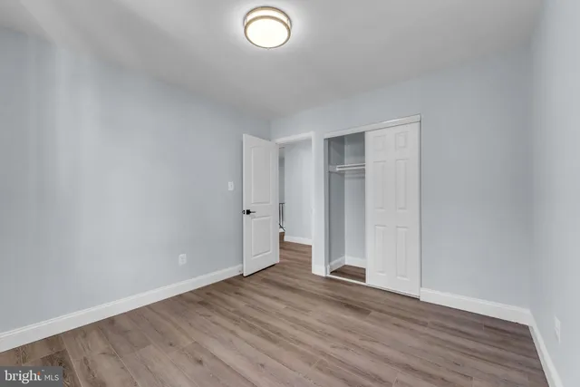 a view of an empty room and wooden floor