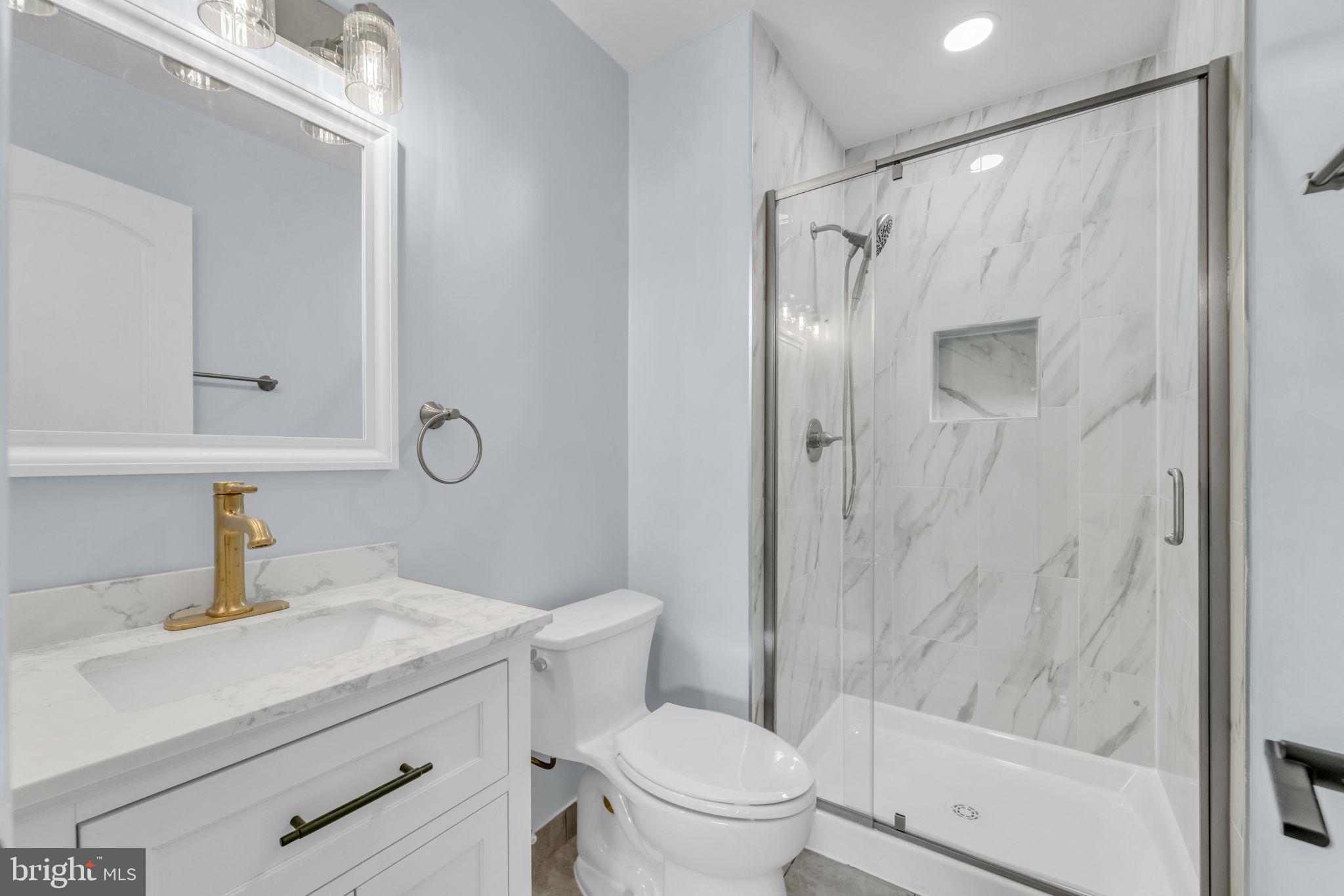 13314 Apgar Place Herndon, VA 20170 - Photo 32 of 39 a bathroom with a shower sink vanity mirror and toilet