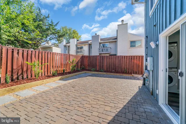 a view of backyard with a wooden fence