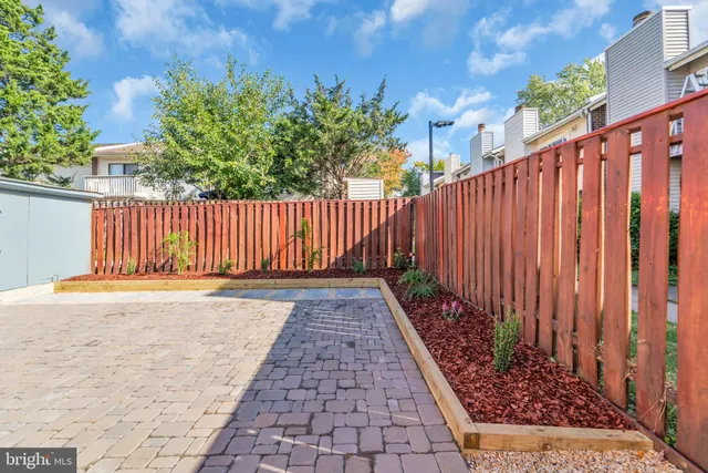 a view of a pathway with a wooden fence