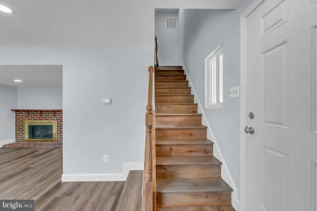 a view of entryway and hall with wooden floor