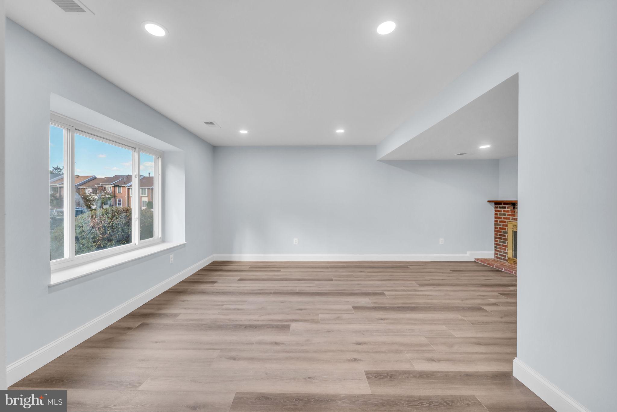 13314 Apgar Place Herndon, VA 20170 - Photo 6 of 39 a view of an empty room with wooden floor and a window