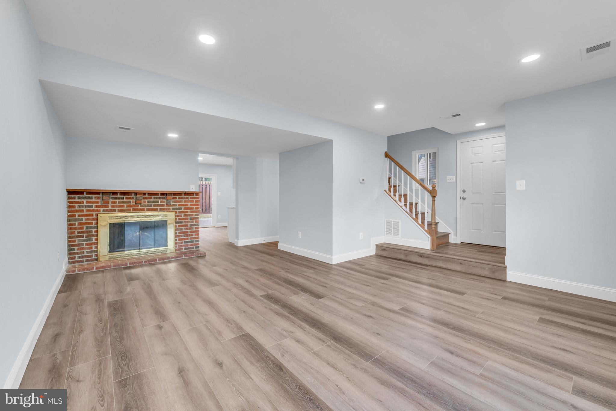 13314 Apgar Place Herndon, VA 20170 - Photo 8 of 39 a view of an empty room with wooden floor fireplace and a window