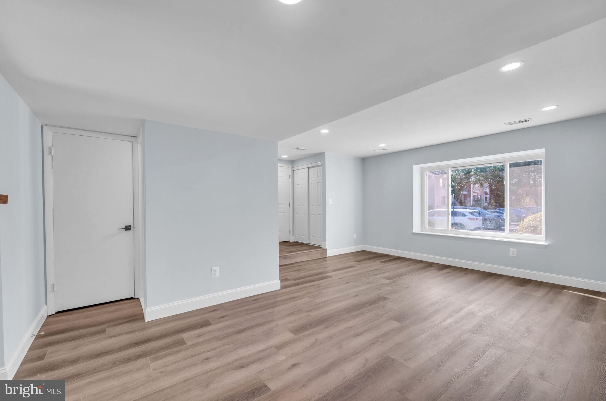 13314 Apgar Place Herndon, VA 20170 - Photo 9 of 39 a view of an empty room with wooden floor and a window