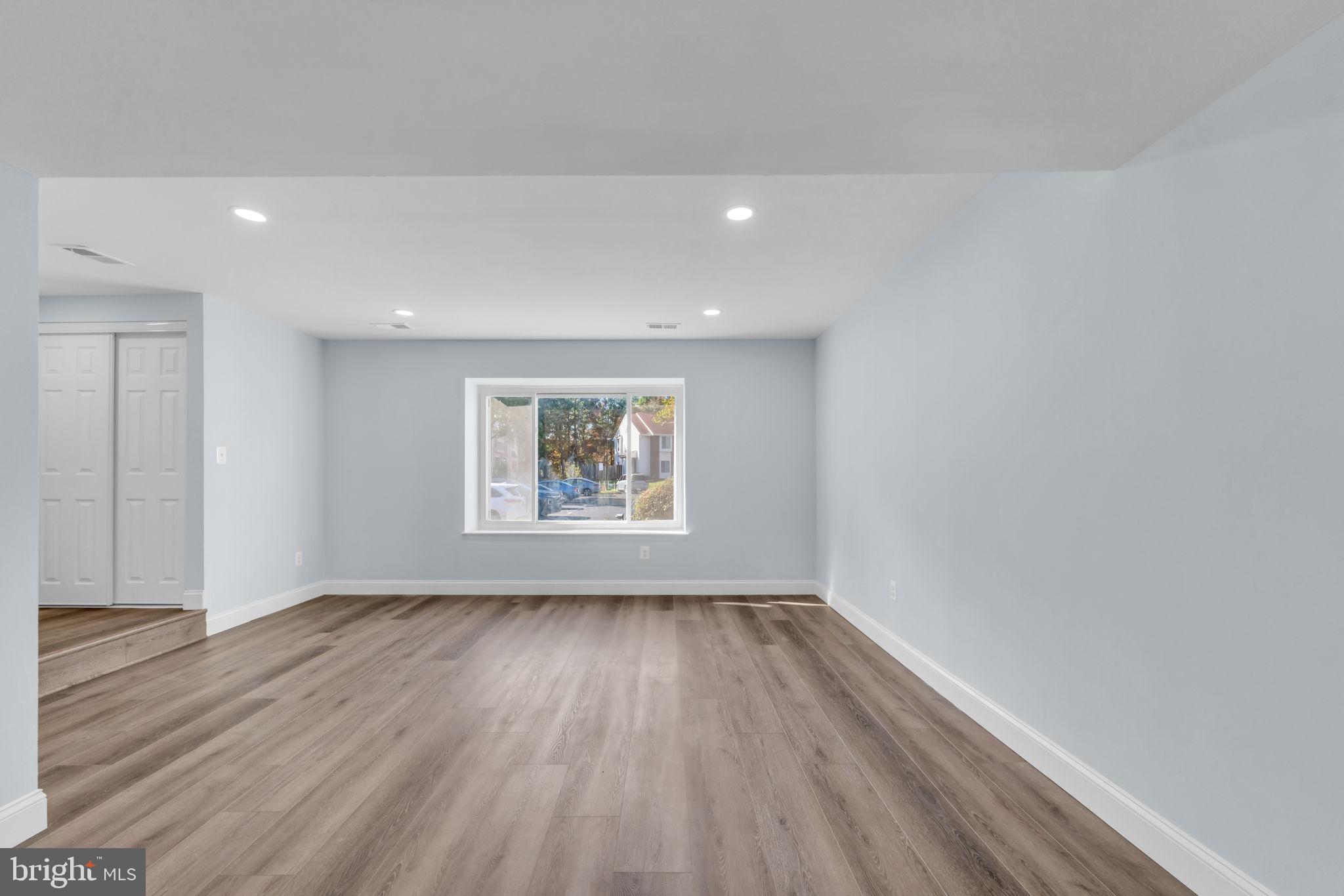 13314 Apgar Place Herndon, VA 20170 - Photo 10 of 39 a view of an empty room with wooden floor and a window