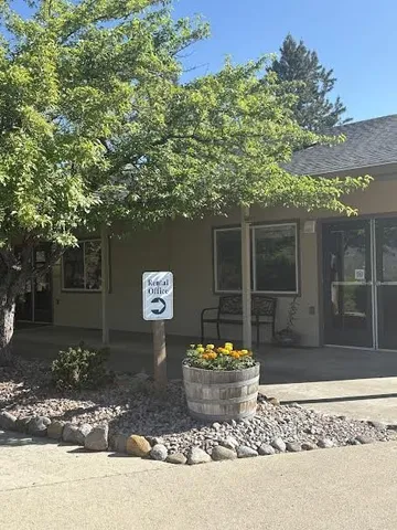 a view of a house with a yard and sitting area