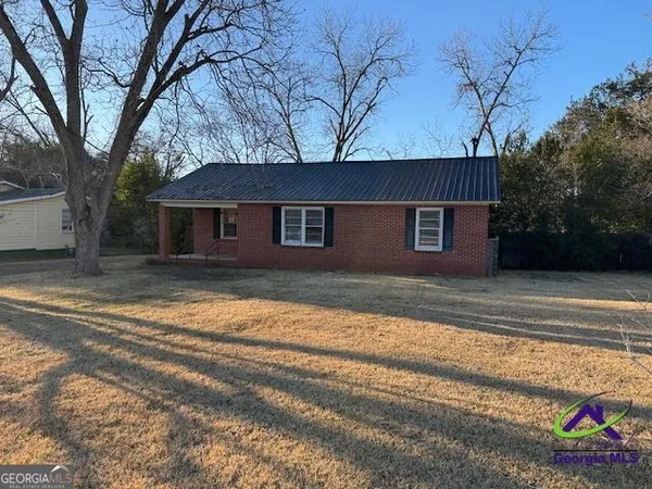a house that has a tree in front of it