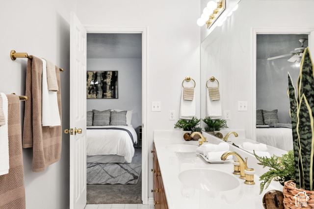 1143 East Mountain Road Logan, UT 84321 - Photo 15 of 64 Dual vanity with white countertops, gold-finish fixtures, and a large mirror