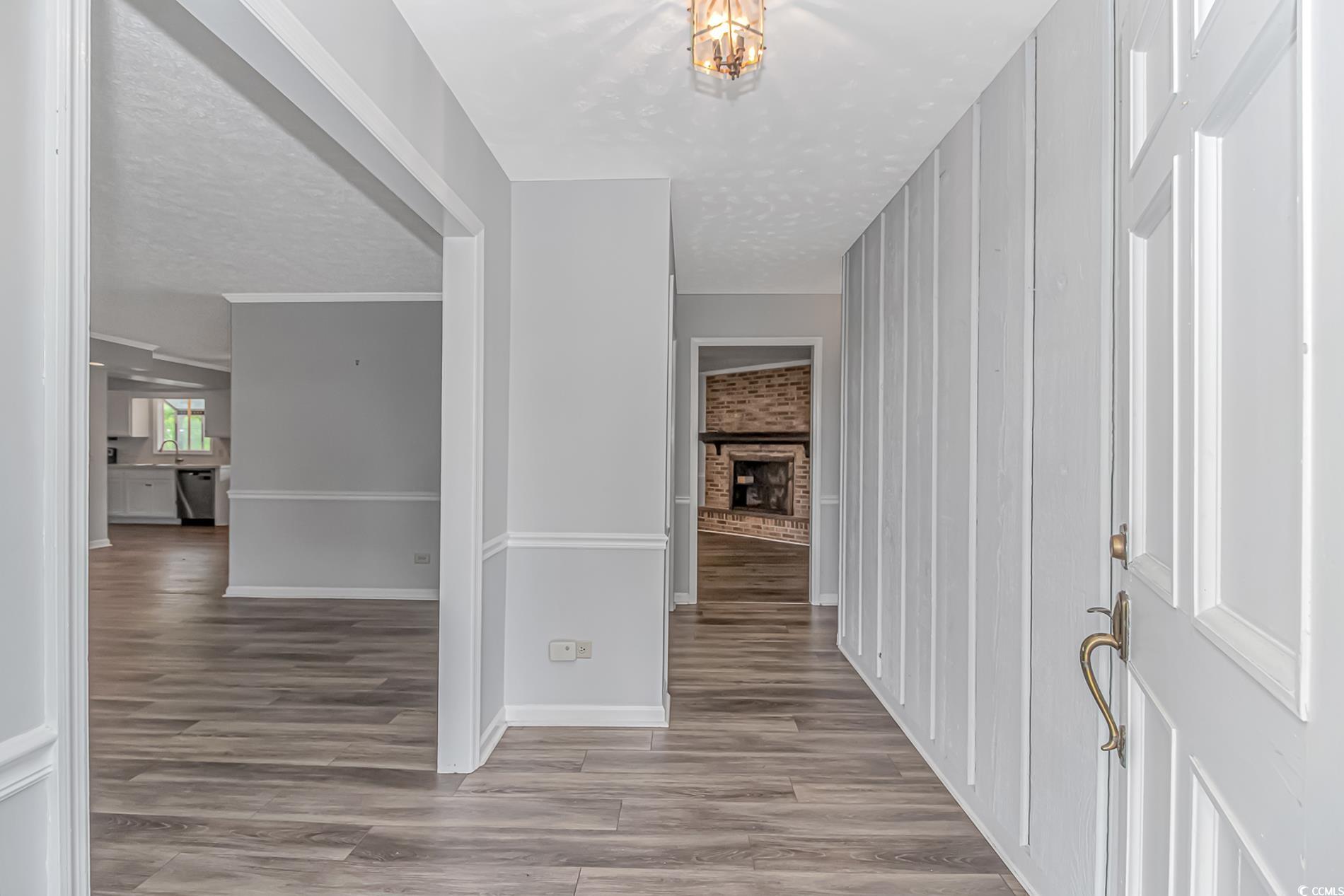 2829 Highway 129 Galivants Ferry, SC 29544 - Photo 3 of 40 Corridor featuring wood finished floors and a textured ceiling