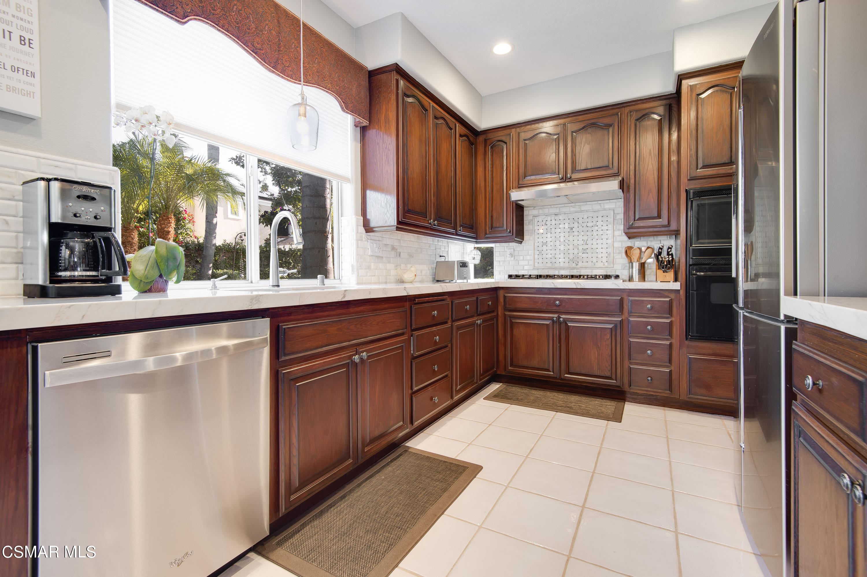 4348 Timberdale Road Moorpark, CA 93021 - Photo 12 of 35 a kitchen with stainless steel appliances granite countertop a sink counter space cabinets and a large window