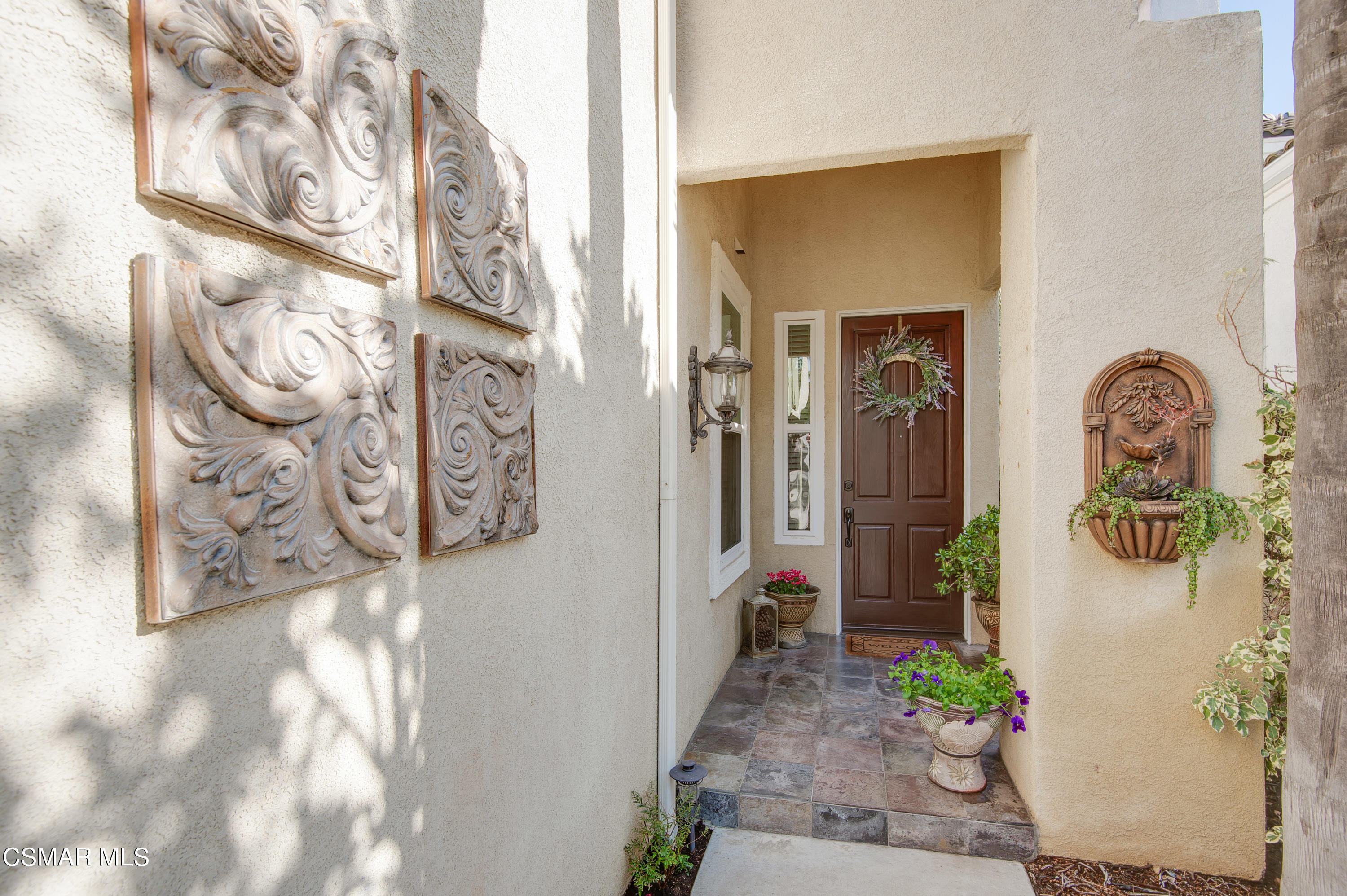 4348 Timberdale Road Moorpark, CA 93021 - Photo 4 of 35 a hallway with painting on the wall and a potted plant