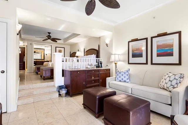 a living room with furniture ceiling fan and a window