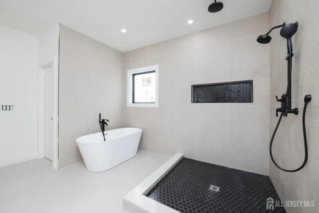 a bathroom with a bath tub and a shower