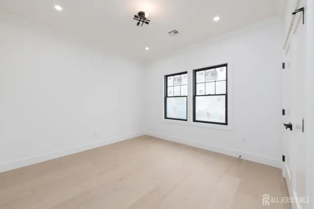 an empty room with windows and closet