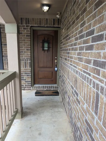 a view of a porch door with wooden floor
