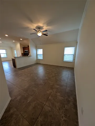 a view of a livingroom with a ceiling fan and window