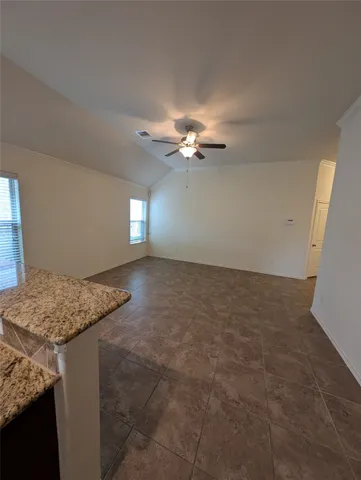 a kitchen with kitchen island granite countertop cabinets and chandelier