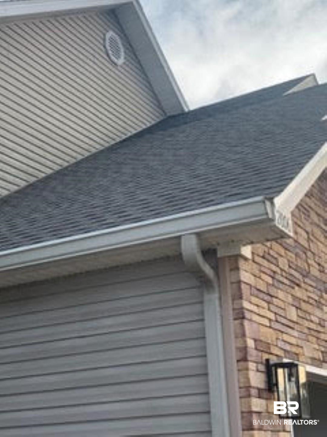 2006 Shelene Way, Unit 2006 Foley, AL 36535 - Photo 20 of 29 Exterior details featuring a downspout, gutters, roof with shingles, and stone siding