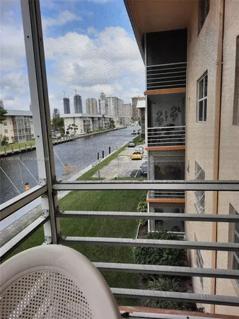a view of balcony with two couches and wooden floor