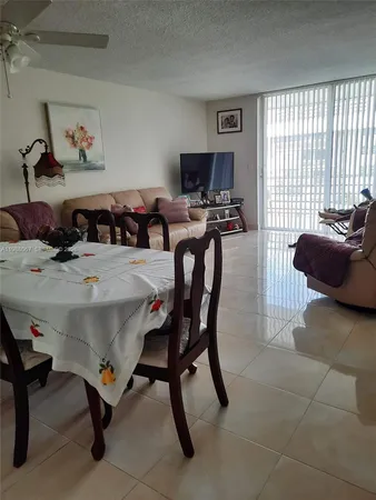 a view of a dining room with furniture and a window