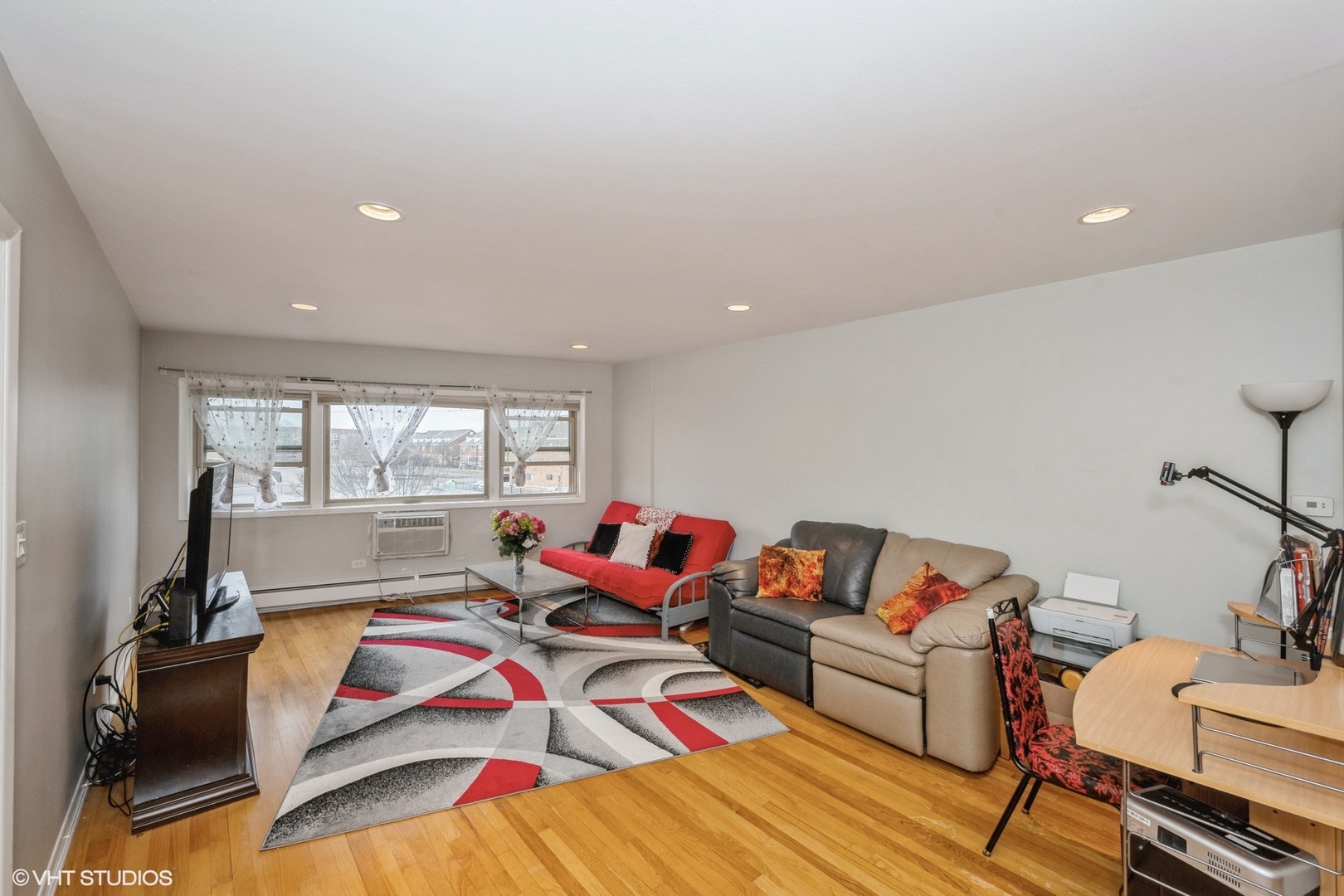8161 Niles Center Road, Unit 3A Skokie, IL 60077 - Photo 3 of 12 a living room with a couch and a dining table with rug floor