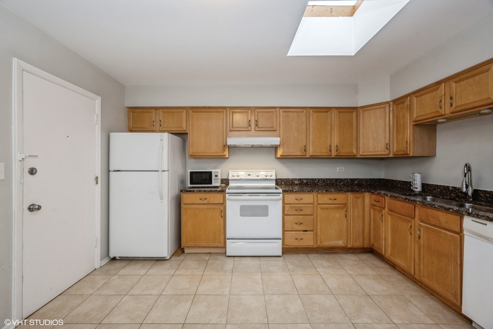 8161 Niles Center Road, Unit 3A Skokie, IL 60077 - Photo 4 of 12 a kitchen with a refrigerator sink and cabinets
