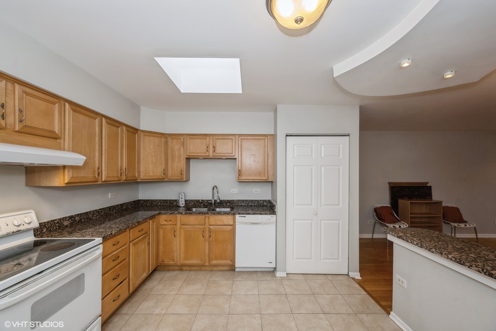 8161 Niles Center Road, Unit 3A Skokie, IL 60077 - Photo 5 of 12 a kitchen with granite countertop a sink stove and cabinets