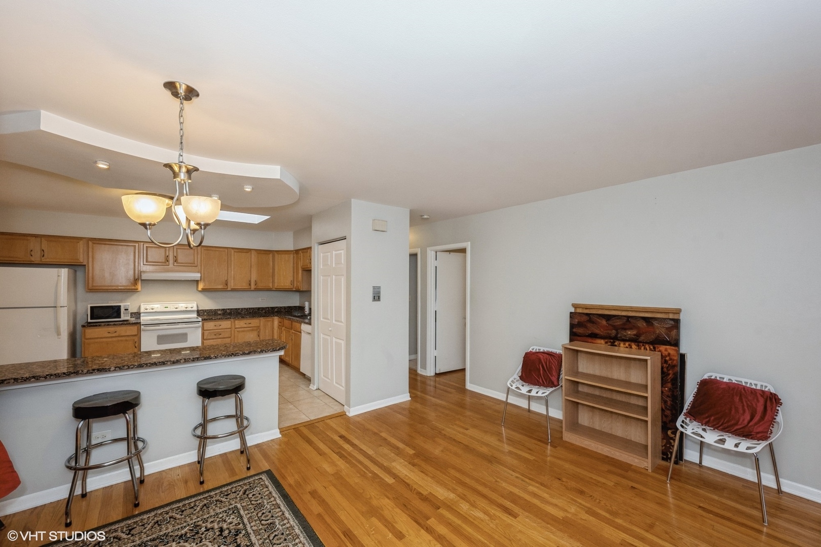 8161 Niles Center Road, Unit 3A Skokie, IL 60077 - Photo 6 of 12 a bedroom with a bed a dresser and chair