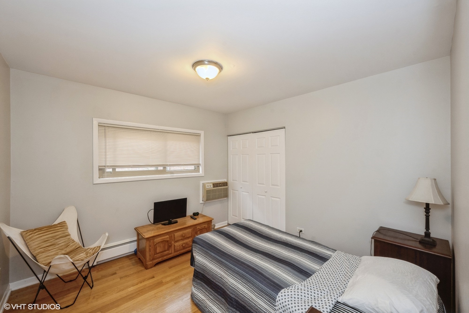 8161 Niles Center Road, Unit 3A Skokie, IL 60077 - Photo 9 of 12 a bedroom with furniture and a fireplace