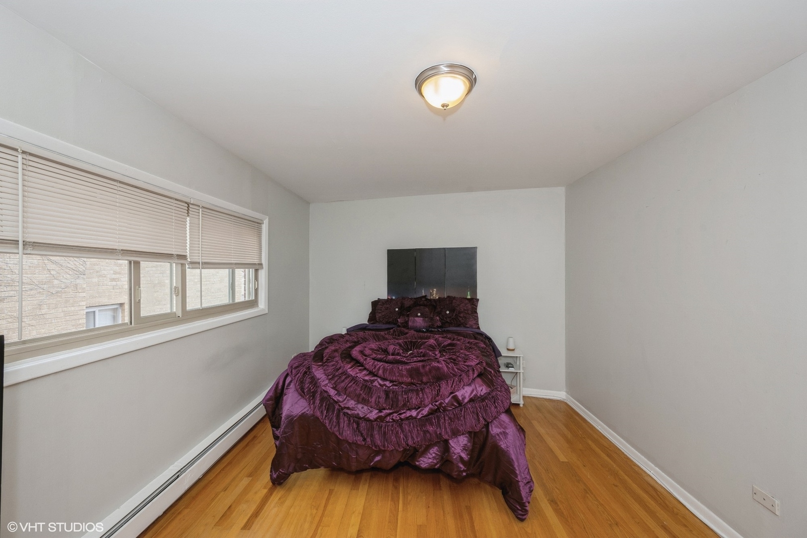 8161 Niles Center Road, Unit 3A Skokie, IL 60077 - Photo 10 of 12 a bedroom with a bed and wooden floor