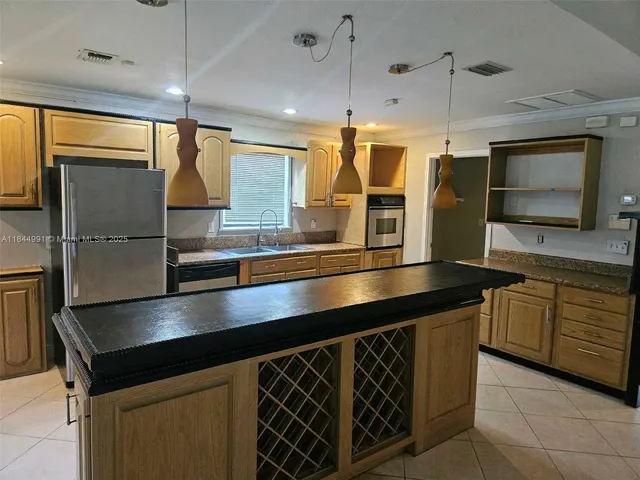 a kitchen with counter top space cabinets and stainless steel appliances