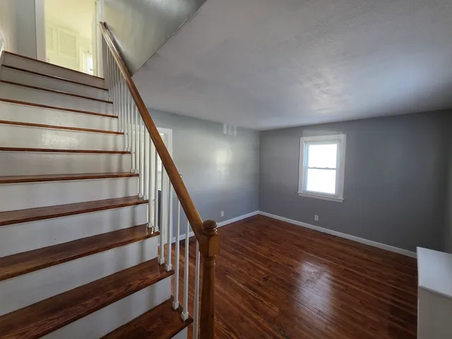 a view of entryway with wooden floor and window