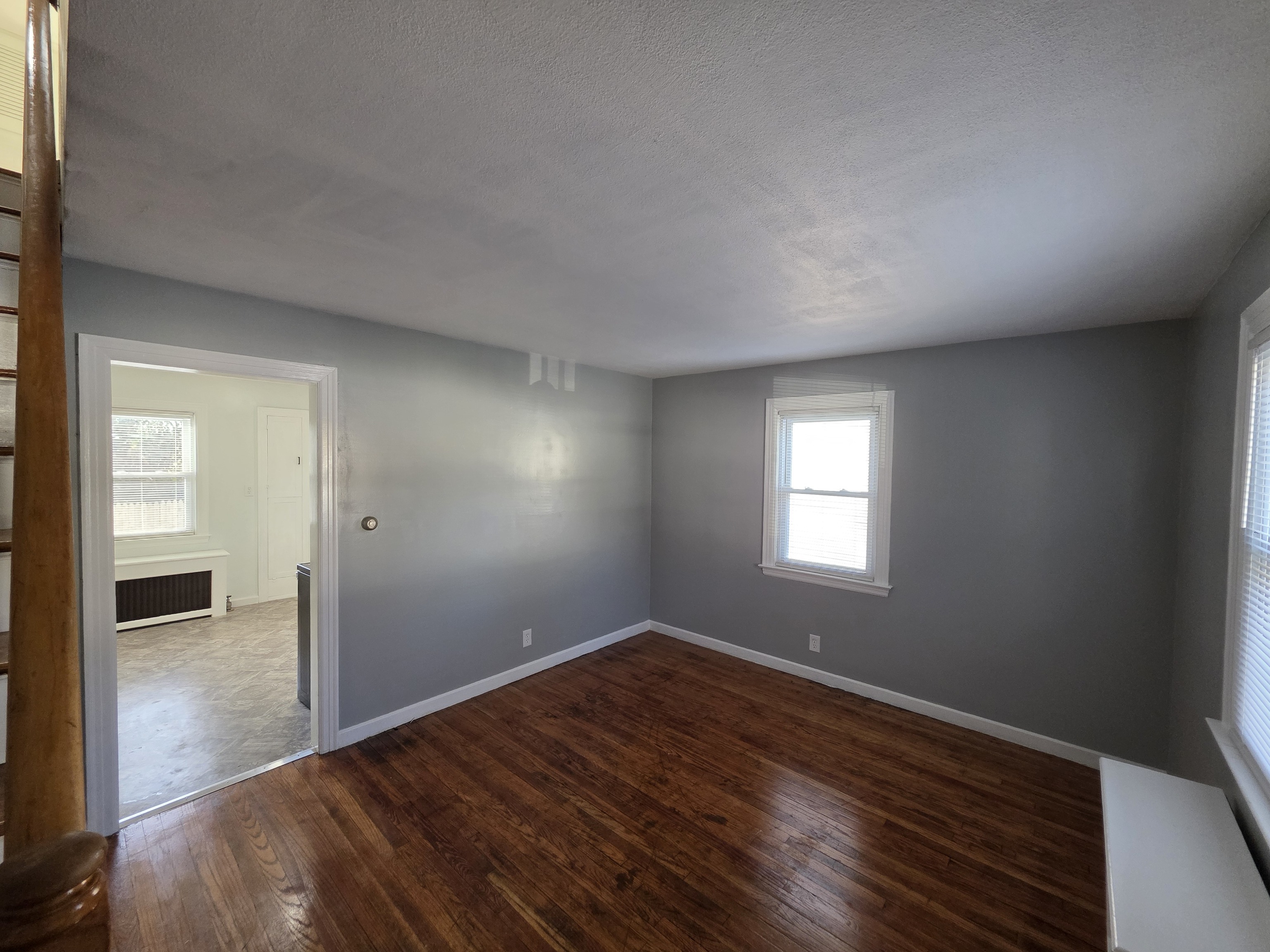 15 Keller Avenue Enfield, CT 06082 - Photo 3 of 13 an empty room with wooden floor and windows
