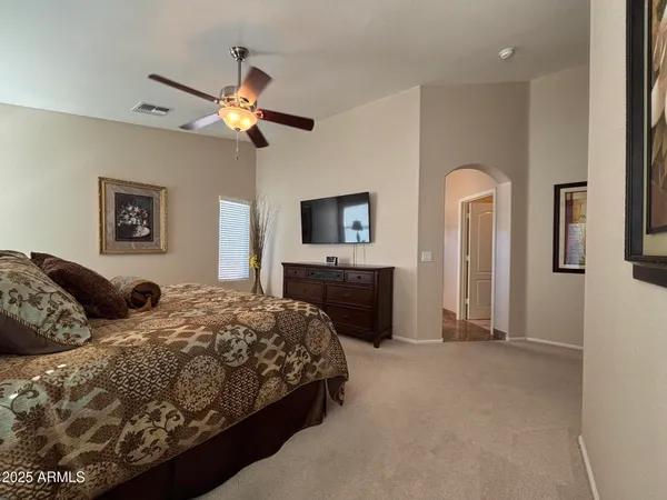 a bedroom with double bed and a chandelier