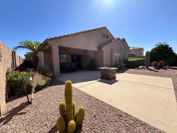 a view of a patio with couches table and chairs and potted plants