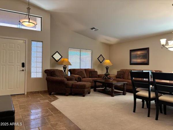 a living room with furniture a window and a flat screen tv