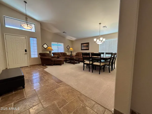 a view of a livingroom with furniture and chandelier