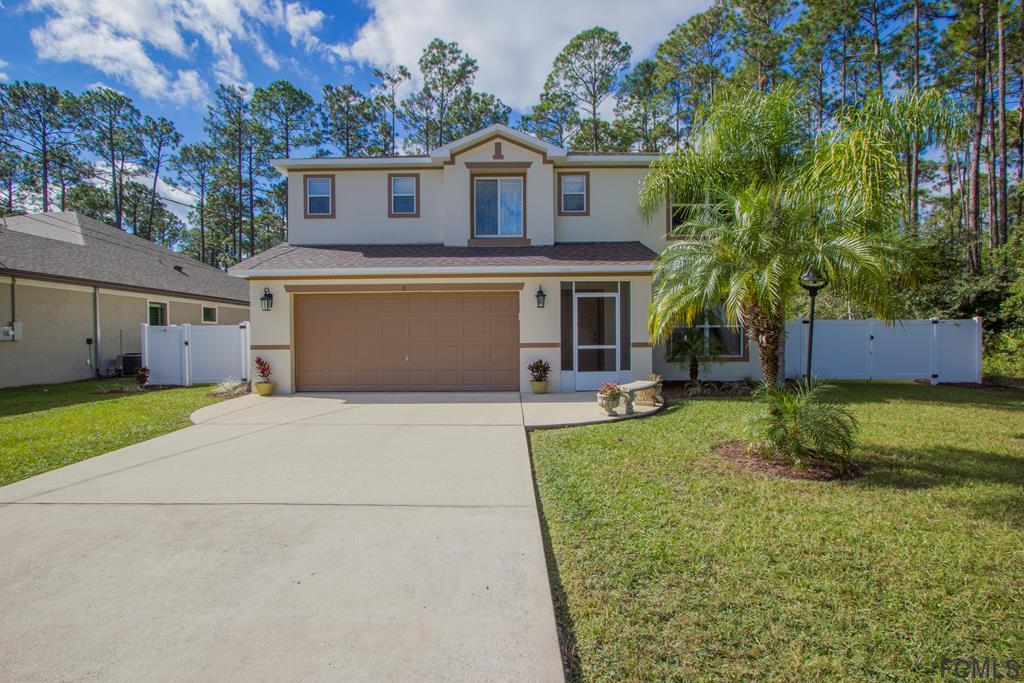 3 Riddle Place Palm Coast, FL 32164 - Photo 1 of 47 a front view of a house with a yard and a garage