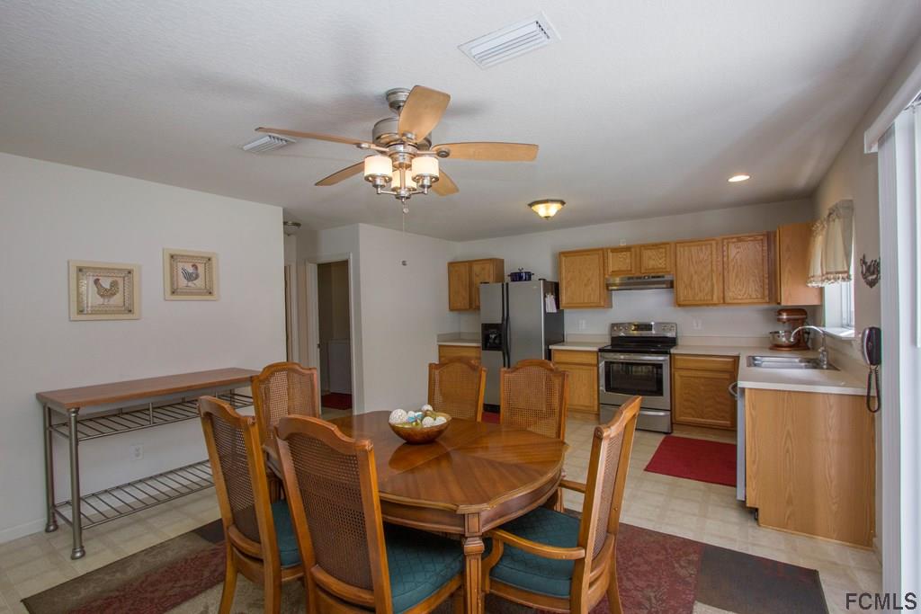 3 Riddle Place Palm Coast, FL 32164 - Photo 11 of 47 a view of a dining room with furniture and wooden floor