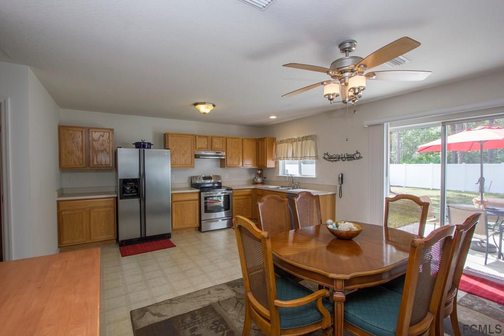 3 Riddle Place Palm Coast, FL 32164 - Photo 12 of 47 a view of a dining room with furniture and a chandelier