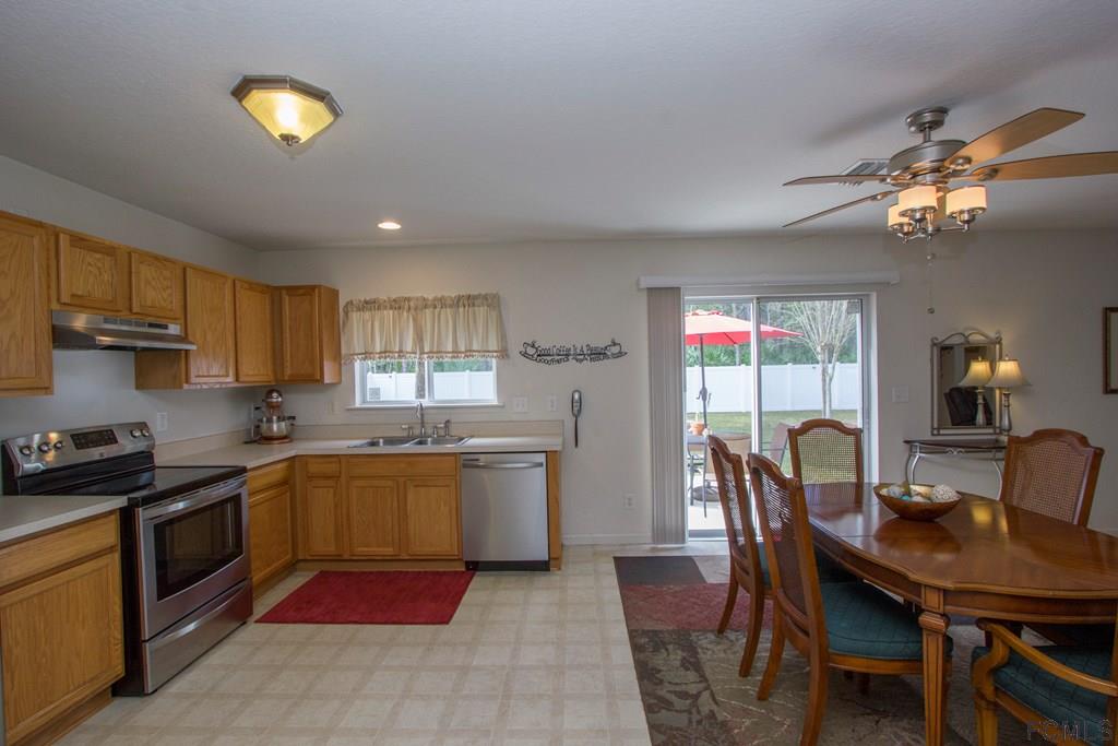3 Riddle Place Palm Coast, FL 32164 - Photo 13 of 47 a kitchen with a table chairs sink and cabinets