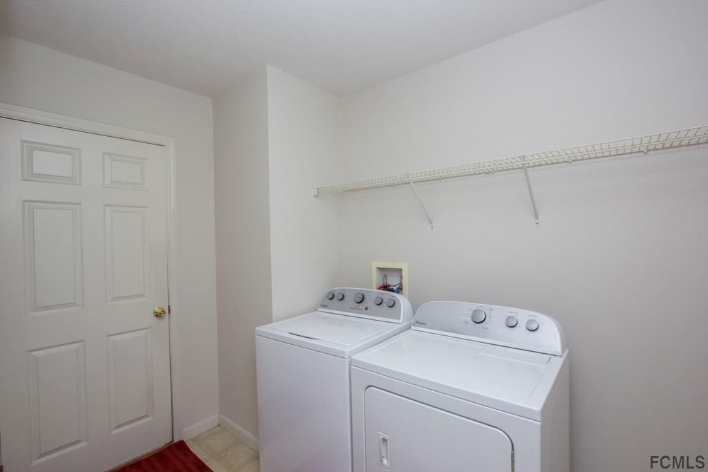 3 Riddle Place Palm Coast, FL 32164 - Photo 15 of 47 a utility room with dryer and washer