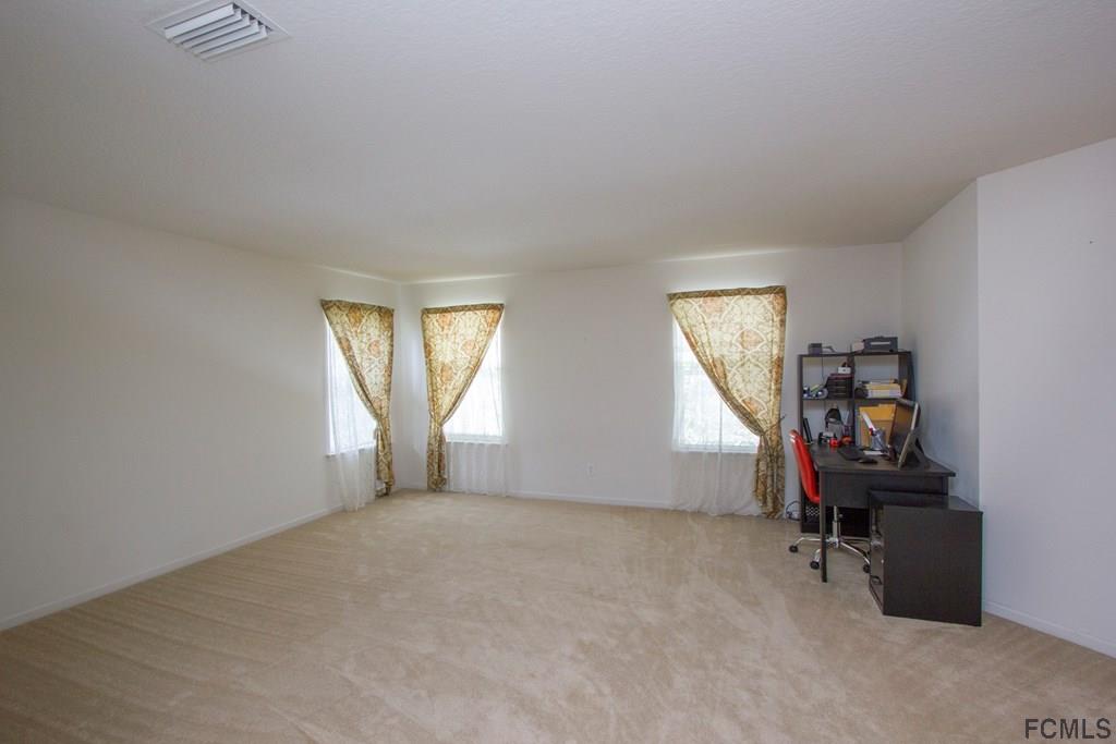 3 Riddle Place Palm Coast, FL 32164 - Photo 19 of 47 an empty room with a window and a mirror