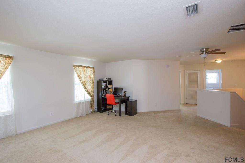 3 Riddle Place Palm Coast, FL 32164 - Photo 20 of 47 a view of a livingroom with workspace and a window