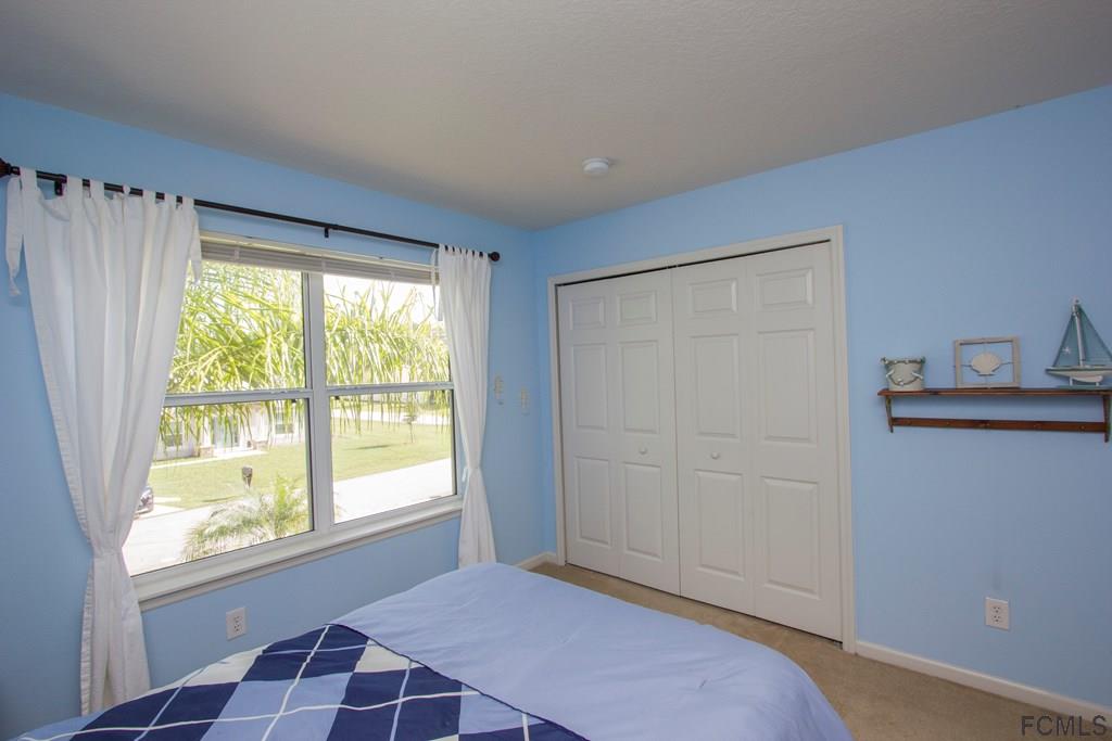 3 Riddle Place Palm Coast, FL 32164 - Photo 22 of 47 a bedroom with a bed and a window