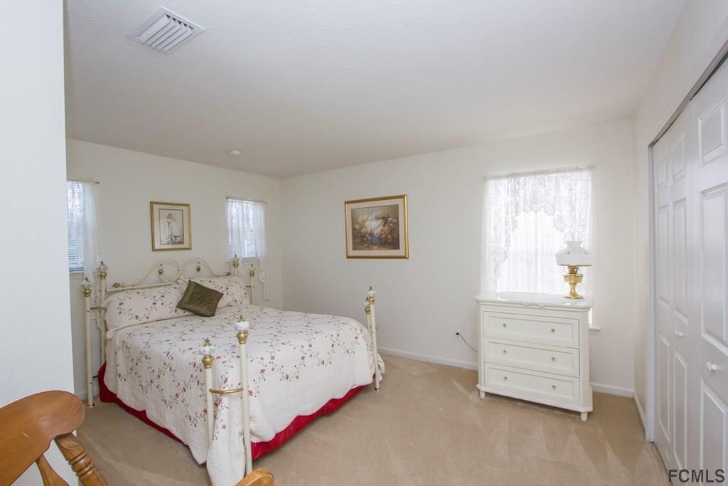 3 Riddle Place Palm Coast, FL 32164 - Photo 27 of 47 a bedroom with a bed and a window