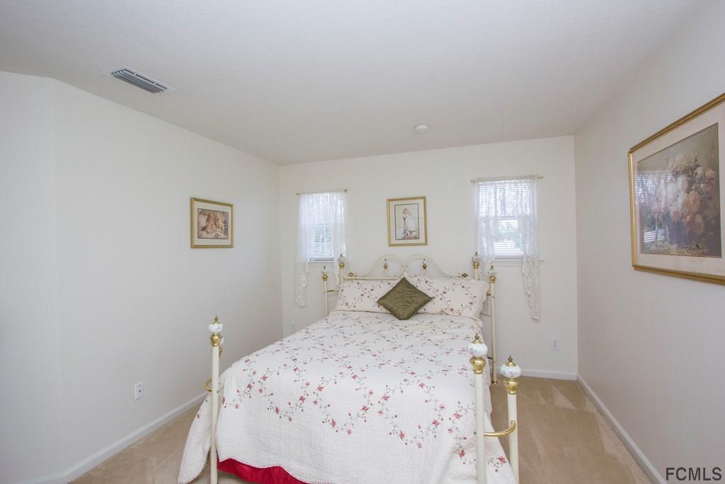 3 Riddle Place Palm Coast, FL 32164 - Photo 28 of 47 a bedroom with a bed and a window