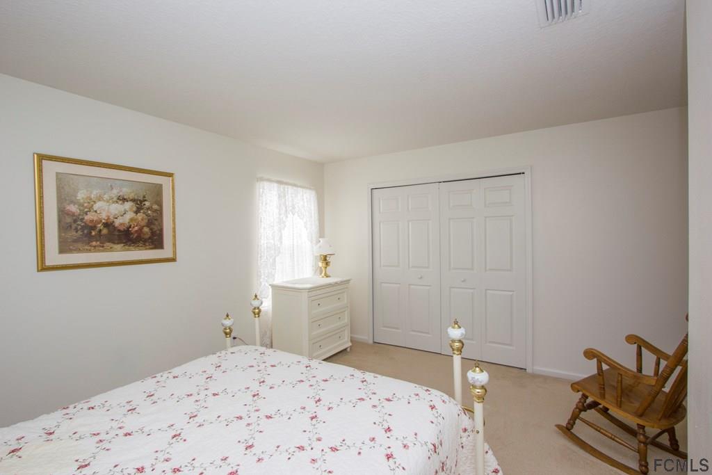 3 Riddle Place Palm Coast, FL 32164 - Photo 29 of 47 a bedroom with a bed and the view of bathroom