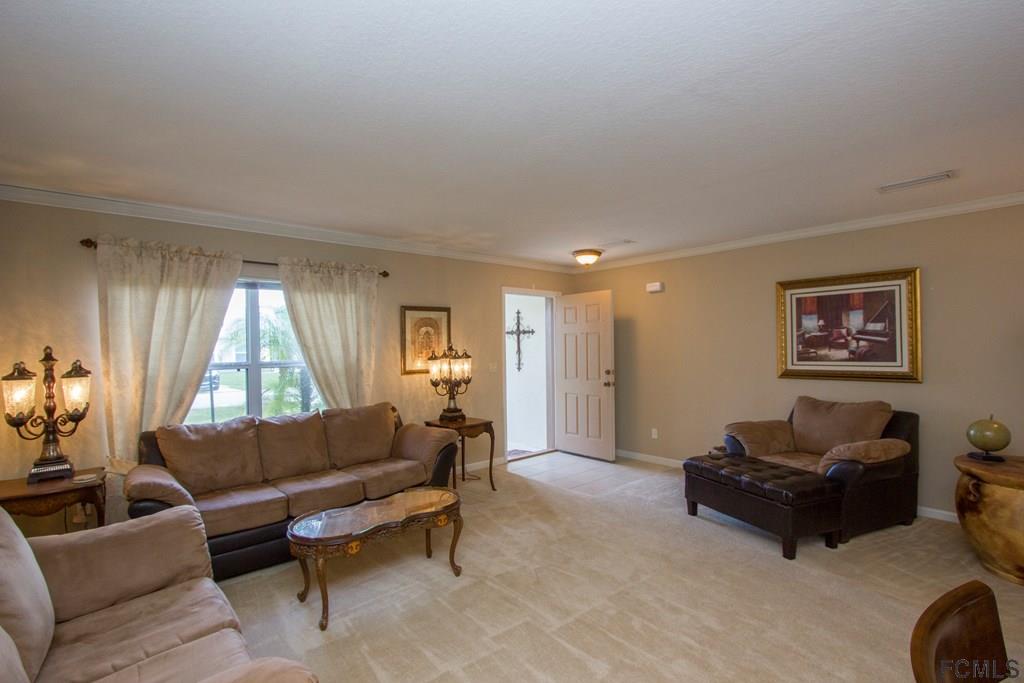 3 Riddle Place Palm Coast, FL 32164 - Photo 4 of 47 a living room with furniture and a window